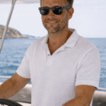 Peter Johnson captain of Primacharter steering a Lagoon 50 catamaran in the Mediterranean